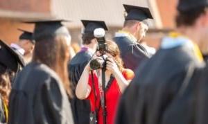 A photographer takes photos at graduation.